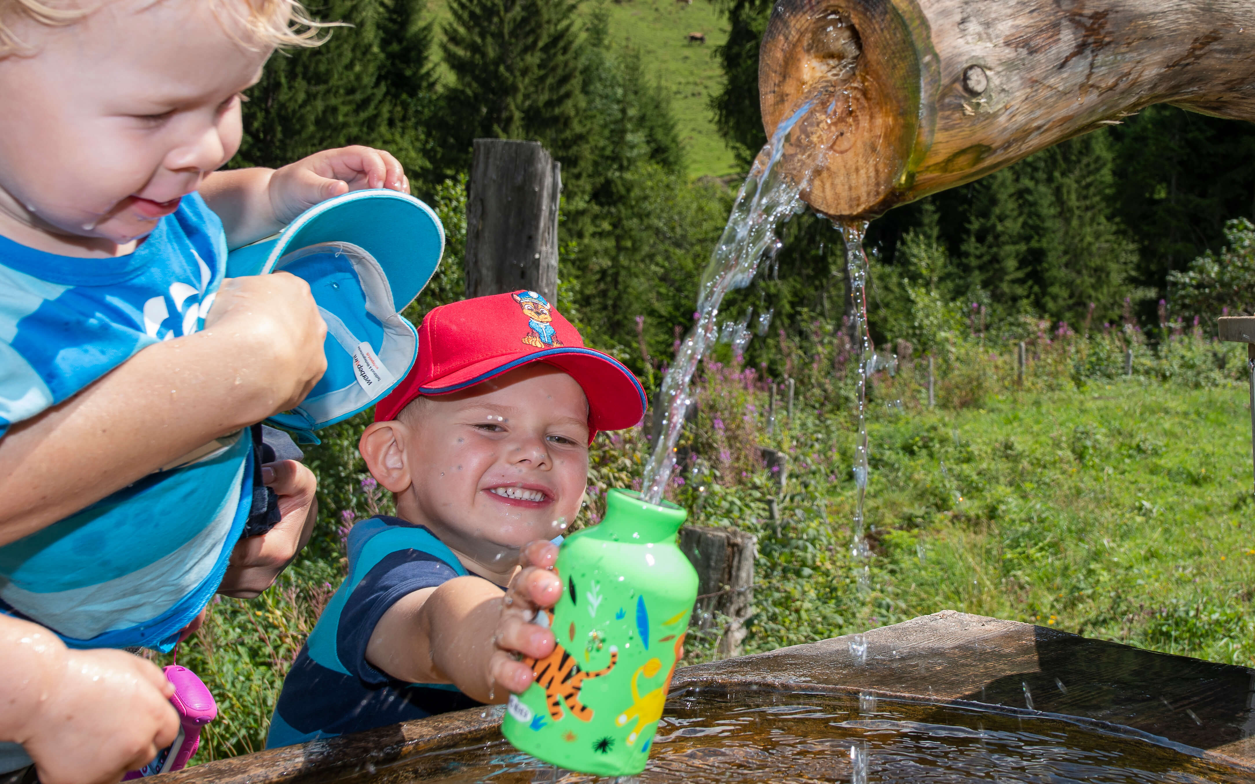 Foto Zwei Buben füllen ihre Trinkwasser am Brunnen -zum Foto