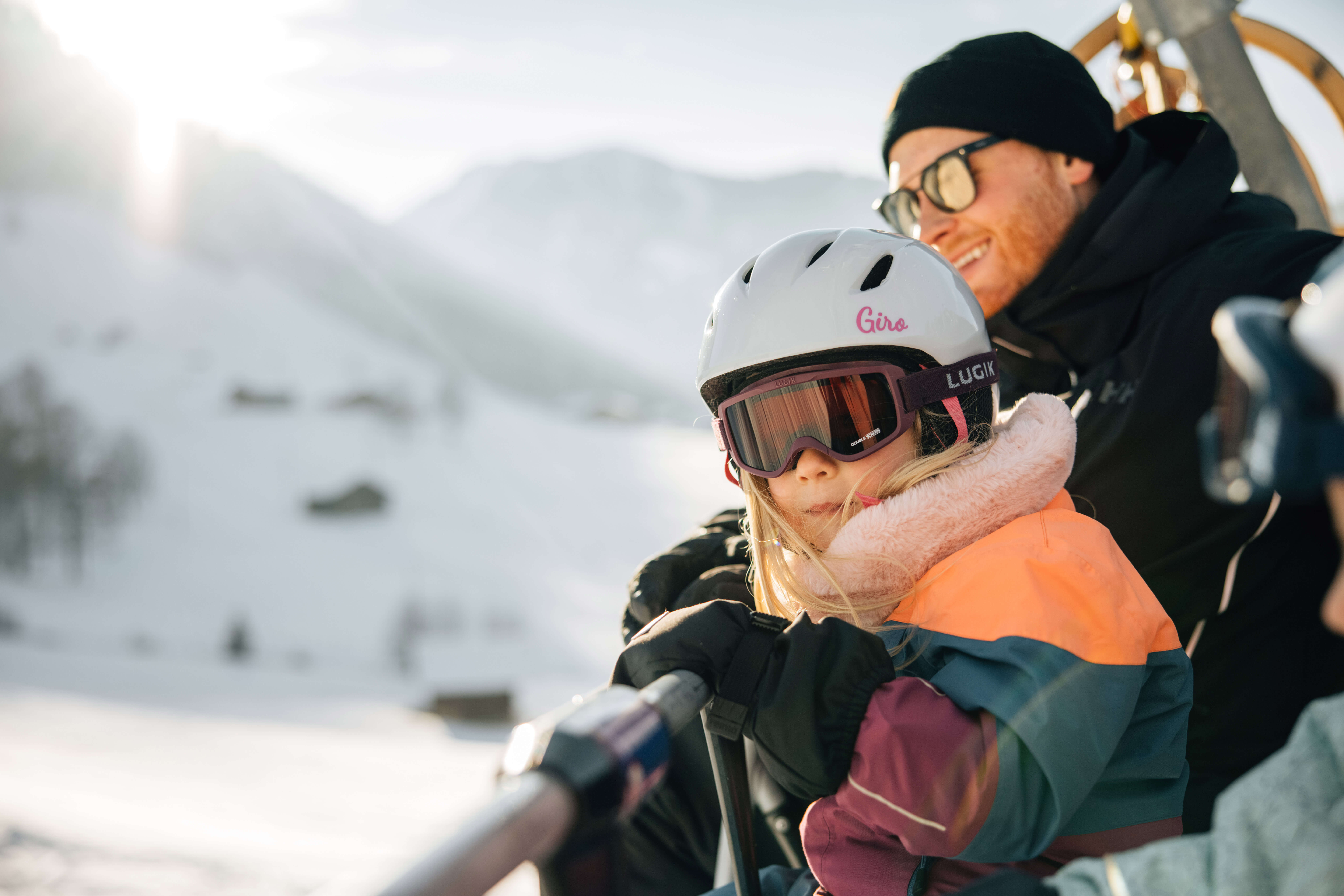 Picture Family sitting on the chairlift - to the picture