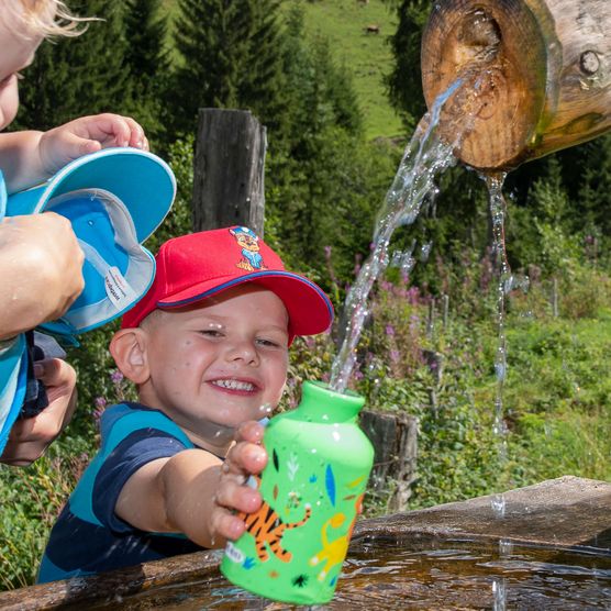 Foto Zwei Buben füllen ihre Trinkwasser am Brunnen -zum Foto